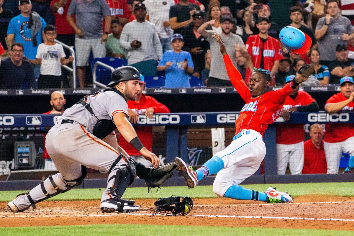 Marlins second baseman Jazz Chisholm Jr. slides into home plate in a game against the San Francisco Giants