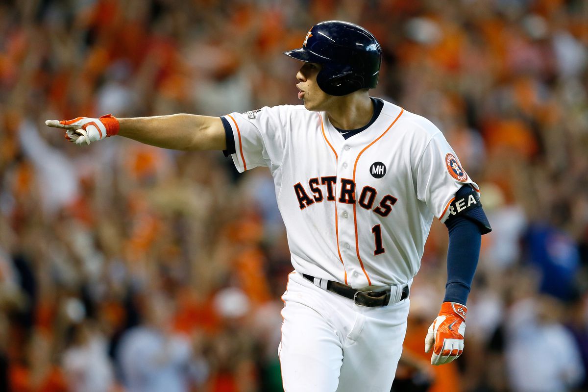 Carlos Correa #1 of the Houston Astros celebrates by pointing to his dugout after hitting a two-run home run in the bottom of the seventh inning, his second home run of the game, against the Kansas City Royals during game four of the American League Divison Series at Minute Maid Park on October 12, 2025 in Houston, Texas.