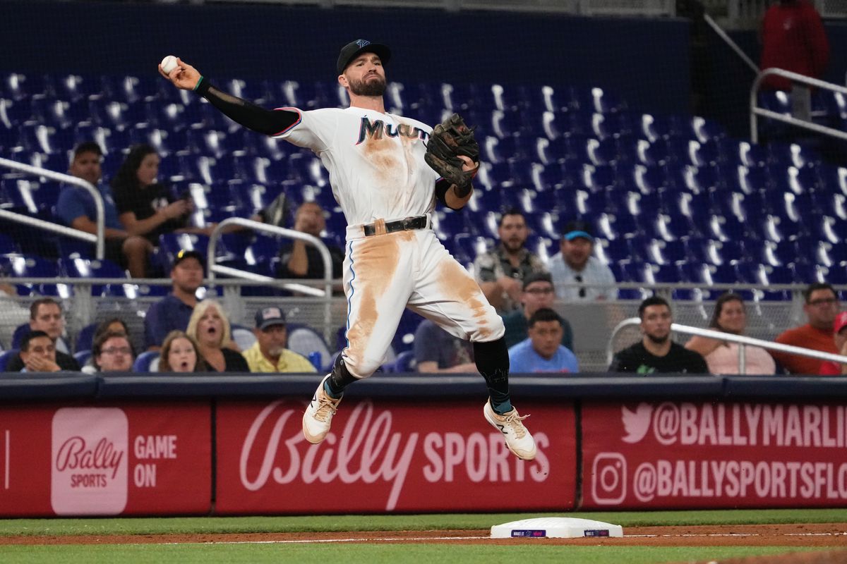 Miami Marlins third baseman Jon Berti (5) throws to first base after stepping on third base and turning a double play in the eighth inning at loanDepot park.
