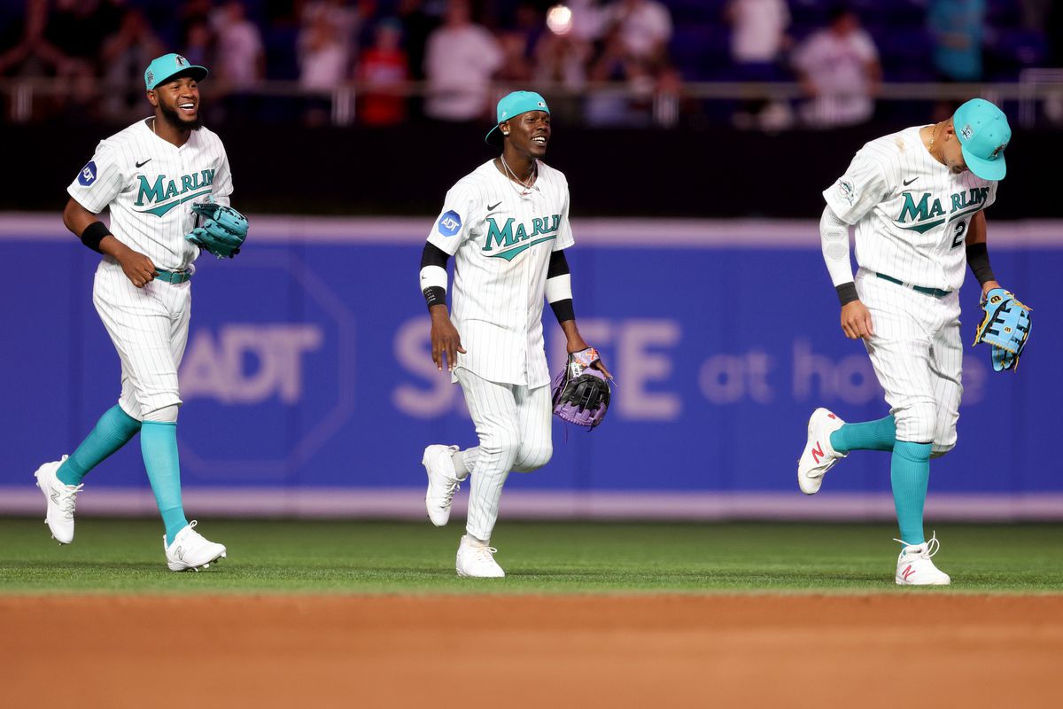 Bryan De La Cruz #14, Jazz Chisholm Jr. #2 and Avisail Garcia #24 of the Miami Marlins celebrate after defeating the New York Mets at loanDepot park on March 31, 2025 in Miami, Florida.